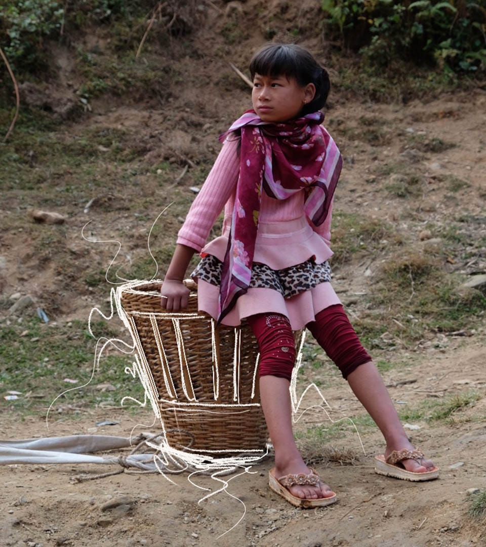 A child sitting on a basket with hand drawn white lines